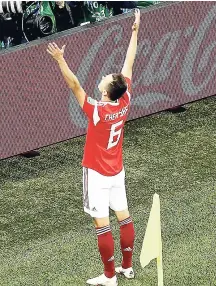  ??  ?? Russia’s Denis Cheryshev celebrates after scoring his side’s second goal against Egypt during the Group A match between Russia and Egypt at the 2018 World Cup.