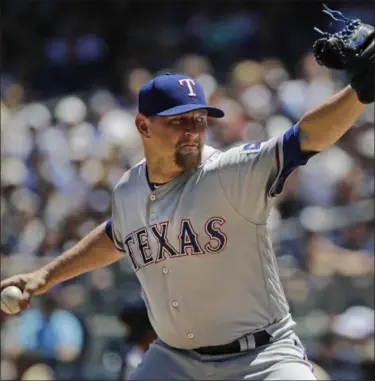  ?? FRANK FRANKLIN II — THE ASSOCIATED PRESS ?? Texas Rangers’ Austin Bibens-Dirkx delivers a pitch during the first inning of a baseball game against the New York Yankees Saturday in New York.