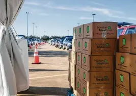  ?? Courtesy / Houston Food Bank ?? Cars line up April 29 at the Berry Center in Cypress for boxes prepared by the Houston Food Bank. Every dollar donated pays for three meals.