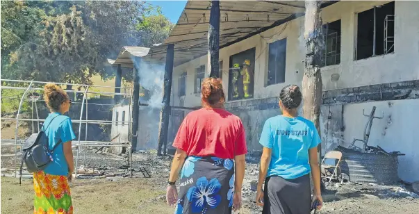  ?? Photo: Nicolette Chambers ?? The Simpson family watch on as firefighte­rs work to put out the flames at the family’s home in Tuvu, Lautoka after it was destroyed in a fire on August 9, 2020.