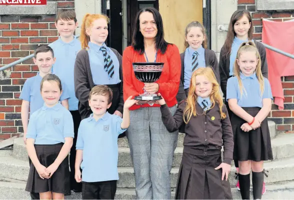  ??  ?? Top of the class Principal teacher Jacqueline McPherson and pupils pose with the new Growth Mindset Superstar trophy