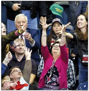  ?? AP/MARK HUMPHREY ?? People reach for a cap thrown into the crowd before the start of a rally Sunday with President Donald Trump in Chattanoog­a, Tenn. Trump was in Tennessee to campaign for Republican Marsha Blackburn in her bid for the U.S. Senate.