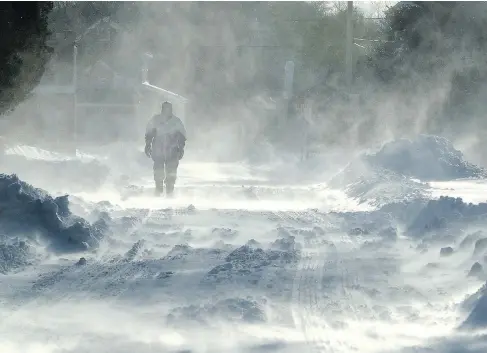  ?? DALE GERHARD / THE PRESS OF ATLANTIC CITY VIA AP ?? A pedestrian walks through blowing snow in Cape May Court House, N.J., on Friday as high winds and bitter cold temperatur­es gripped the region.