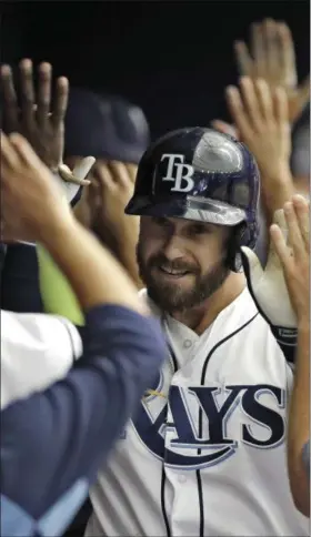  ?? CHRIS O’MEARA — THE ASSOCIATED PRESS ?? Tampa Bay Rays’ Evan Longoria high-fives teammates in the dugout after hitting a tworun home run off Baltimore Orioles starting pitcher Ubaldo Jimenez in the sixth inning of a baseball game Wednesday in St. Petersburg, Fla. The Rays’ Mallex Smith also...