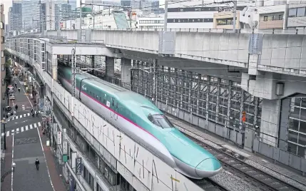  ?? AFP ?? An E5 series shinkansen is pictured at the Tokyo Station yesterday.