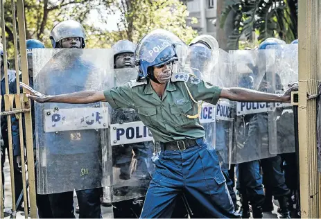  ?? Picture: AFP ?? The gates to the Rainbow Towers Hotel in Harare are blocked by Zimbabwean riot police. The election results were announced this week from the Towers, provoking discontent and violence. The main opposition party, the MDC Alliance, claimed the results were rigged.