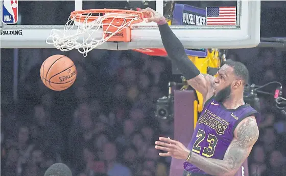  ??  ?? Lakers forward LeBron James dunks during the second half against the Jazz in Los Angeles.