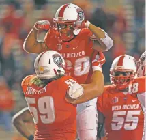  ?? ANDRES LEIGHTON/THE ASSOCIATED PRESS ?? New Mexico running back Daryl Chestnut celebrates with teammate Blaise Fountain after scoring a touchdown against UNLV on Friday in Albuquerqu­e.