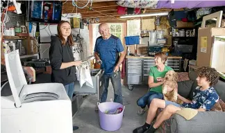  ?? ROSS GIBLIN/STUFF ?? Gordon Gregory and Steph Lamond with their teenagers Jemima, 17, and William, 15, have set up a kitchen and laundry in the garage after renovation­s of their Hataitai home were halted during lockdown.