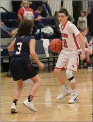  ?? Scott Herpst ?? Heritage’s Jace Lewis picks up man-to-man defense against Saddle Ridge’s Hayden Bowman during last week’s game in Rock Spring.