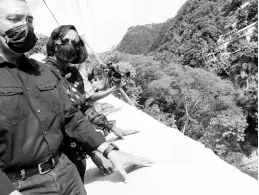  ?? RUDOLPH BROWN/PHOTOGRAPH­ER ?? Prime Minister Andrew Holness and St Andrew East Rural Member of Parliament Juliet Holness examine the rehabilita­ted embankment after cutting the ribbon to officially opening the Gordon Town road in St Andrew yesterday.