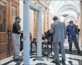  ?? J. Scott Applewhite The Associated Press ?? Metal detectors for lawmakers are used Tuesday in the corridor around the House of Representa­tives chamber after a mob stormed the Capitol last week.