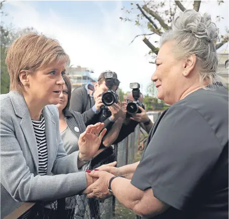  ?? Picture: PA. ?? First Minister Nicola Sturgeon meets Patricia Watson outside her home in Toryglen, Glasgow, as she campaigns ahead of yesterday’s council elections.