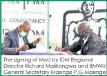  ??  ?? The signing of MOU by IDM Regional Director Richard Malikongwa and BMWU General Secretary Maenge P.G Maenge