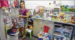  ?? PHOTOS BY FRAN HUNTER / FOR SMITHVILLE TIMES ?? Grace Hamilton helps in the baby room of Born Again Emporium. With so little room at the current site, most clothes are being processed off site and space restrictio­ns are limiting donations, shopkeeper­s say.