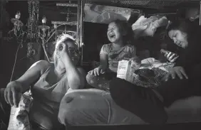  ?? CHRISTINA HOUSE/LOS ANGELES TIMES ?? Emely Ramirez, 6, center, spends time with her mom, Brenda Ramirez, 35, left, and sister, Brenda Lopez, 17, right, at the family’s party decoration shop in South Los Angeles on Monday. Emely was shot in the back at a gas station near their home in South Los Angeles.