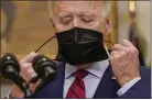  ?? PABLO MARTINEZ MONSIVAIS — THE ASSOCIATED PRESS ?? President Joe Biden removes his mask before speaking on the economy in the Roosevelt Room of the White House in Washington on Saturday.