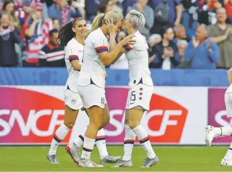  ??  ?? The United States’ Megan Rapinoe, right, kisses teammate and goal scorer Lindsey Horan during the Women’s World Cup Group F match against Sweden on Thursday in Le Havre, France.