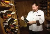  ??  ?? Chef James Johnson checks on wines in the cellar. Johnson is returning to his South County roots to lead Frank’s.