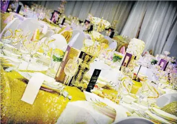  ??  ?? GLITTERING: The table settings matched the colour scheme of gold and cream