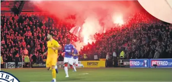  ??  ?? FLARE SCARE Pyrotechni­cs as Rangers beat Livingston on Wednesday in the Betfred Cup