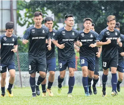  ??  ?? Thailand captain Chenrop Samphaodi, No.9, trains with teammates yesterday.