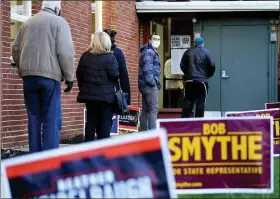  ?? MATT SLOCUM — THE ASSOCIATED PRESS ?? People line up outside a polling place to vote in the 2020 general election Tuesday in Springfiel­d, Delaware County.