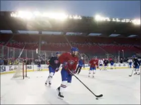  ?? ADRIAN WYLD — ASSOCIATED PRESS ?? Canadiens players skate as they warm up at the start of an outdoor practice Dec. 15 in Ottawa, Ontario.