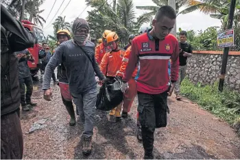  ?? ?? OPERATION: Bodies are carried from the ruins of a building in Cianjur, Indonesia.