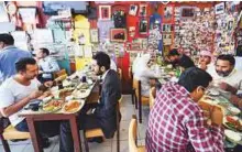  ?? Antonin Kelian Kallouche/Gulf News Archives ?? Diners at a restaurant on Mussallah Road in Bur Dubai. Picture for illustrati­ve purposes only.