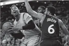  ?? MICHAEL DWYER/AP PHOTO ?? Toronto’s Anthony Bennett, behind, and Cory Joseph, foreground, double-team Boston’s Jared Sullinger on Friday night during the second quarter at the TD Garden. The Celtics lost, 113-103.