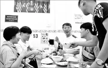  ??  ?? In this photograph taken on Mar 20, customers enjoy a meal at Bun Cha Huong Lien restaurant, now dubbed “bun cha Obama” with a photograph of former US President Barack Obama displayed on the wall, in Hanoi’s old quarter. — AFP photos by Nhac Nguyen