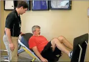  ?? John Popham / Rome News-Tribune ?? Physical therapist assistant Matt Hendricks works with Dave Williams at Floyd Physical Therapy and Rehab.