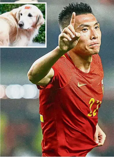  ??  ?? Headed for victory: China’s Yu Dabao celebratin­g after scoring against South Korea in the 2018 World Cup qualifier at the Helong Stadium in Changsha, China, yesterday. Inset: A dog with a China flag on its forehead at the stadium. — Reuters