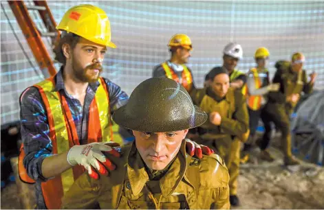  ??  ?? Justin Kendall and other workers install a World War II display at the new National Museum of the US Army. — Washington Post photo by Jahi Chikwendiu