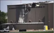  ?? SHABAN ATHUMAN — THE DALLAS MORNING NEWS VIA AP ?? Damage is seen to a hangar after a twin-engine plane crashed into the building in Addison, Texas, on Sunday.