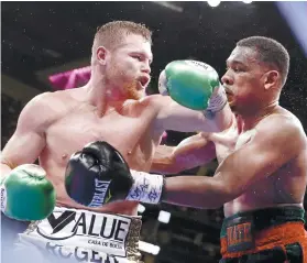  ?? AP FOTO ?? NEW BELT. Canelo Alvarez (left) added Daniel Jacobs’ IBF belt after winning their unificatio­n bout.