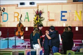  ?? AMANDA VOISARD / AMERICAN-STATESMAN ?? Teacher Hermes Camacho (left) embraces student Oswal Garcia, 18, after a vigil Tuesday evening in honor of Camacho’s close friend, 17-year-old Draylen Mason, who was killed in the second Austin bombing.