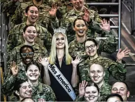  ?? JIM NOELKER / STAFF ?? Miss America and U.S. Air Force Second Lt. Madison Marsh poses with other airmen at the U.S. Air Force Museum on Tuesday. Marsh toured the museum and took questions from attendees. She plans to attend Harvard Kennedy School.