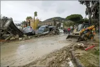  ?? SALVATORE LAPORTA — THE ASSOCIATED PRESS ?? Rescuers remove mud from a street after heavy rainfall triggered landslides Saturday in Casamiccio­la, on the southern Italian island of Ischia.