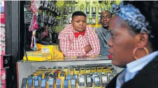  ?? /James Oatway ?? Hustle and bustle: Samantha’s Cell Plus Sound shop in the Joburg CBD. Due to poor policy implementa­tion, small black businesses have fallen into the hands of new players, predominan­tly from the Asian continent.