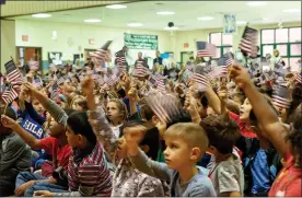  ?? COURTESY OF NORTH PENN SCHOOL DISTRICT ?? Students wave American flags during a Veterans Day ceremony at Gwynedd Square Elementary School in 2019.