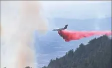  ?? Frederic J. Brown/AFP/Getty Images ?? An aircraft drops fire retardant over a fireTuesda­y in the Angeles National Forest northeast of Los Angeles, Calif.