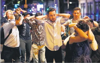  ?? Picture: Reuters ?? HANDS UP. People leave the area after an incident near London Bridge on Saturday night.