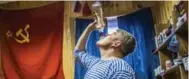  ?? DANIEL BEREHULAK/THE NEW YORK TIMES ?? Researcher­s drink homemade vodka at a station on King George Island in Antarctica.