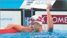  ?? AP ?? Tang Qianting celebrates winning the gold medal in the women's 100m breaststro­ke final on Tuesday.