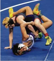  ?? Jason Fochtman / Houston Chronicle ?? Euless Trinity junior Mack Beggs, top, drives Morton Ranch’s Chelsea Sanchez into the mat during the Class 6A girls 110-pound championsh­ip final.