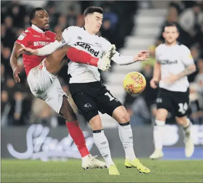  ?? PICTURE: MIKE EGERTON/PA WIRE ?? STRETCHED: Nottingham Forest’s Tendayi Darikwa lunges for the ball in a duel with Derby County’s Tom Lawrence in last night’s goalless Championsh­ip match at Pride Park. The point was enough to lift Derby above Sheffield United into fourth place.