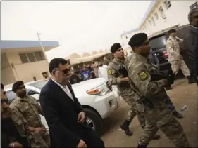  ??  ?? Faiez Alsarraj, head of Libya’s high national elections commission visits the headquarte­rs in Tripoli after a suicide bombing on Wednesday. AP PHOTO/MOHAMED BEN KHALIFA