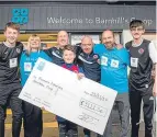  ?? ?? Monifieth Athletic members picking up their cheque at Barnhill Co-op.